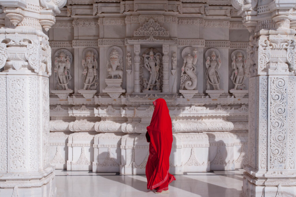 indian woman in temple in red sari