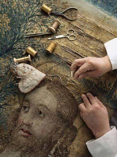restoration of raphael's tapestry. a nun repairs a tapestry designed by raphael using threads of over 6000 colors