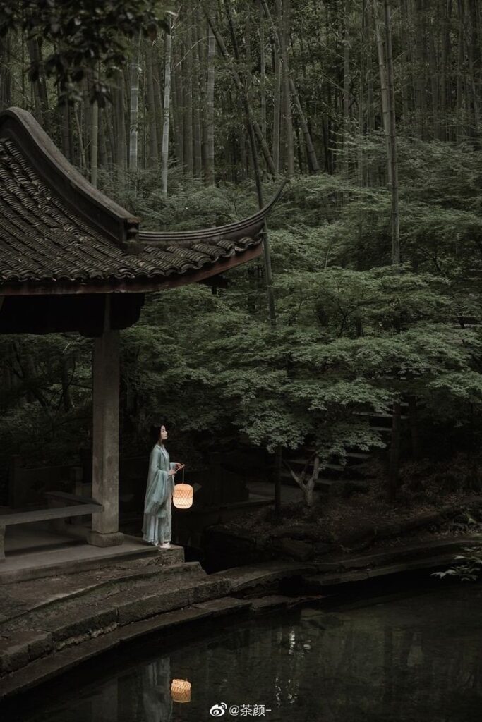 lady with lantern in bamboo forest, Japan